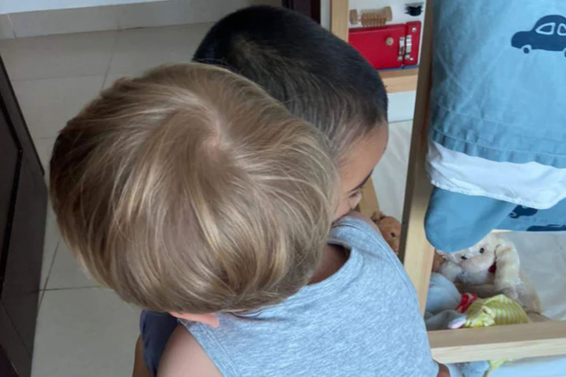 Two kids hug each other.