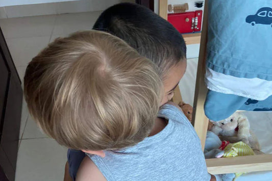 Two kids hug each other.