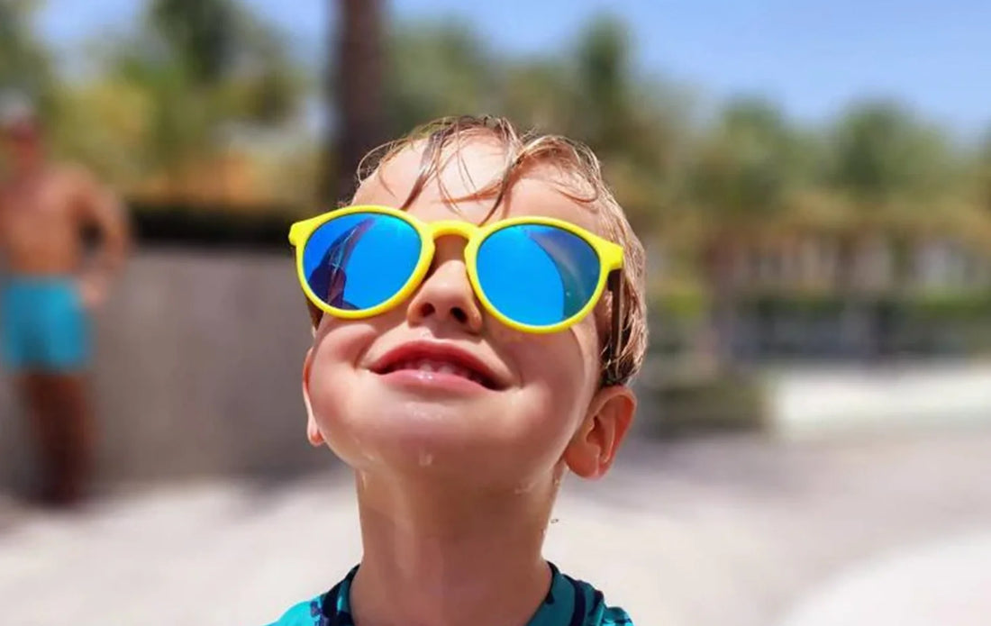 A cool kid wearing Jojo yellow sunglasses.