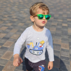 A kid wearing cool shades struts his stuff in the sun.